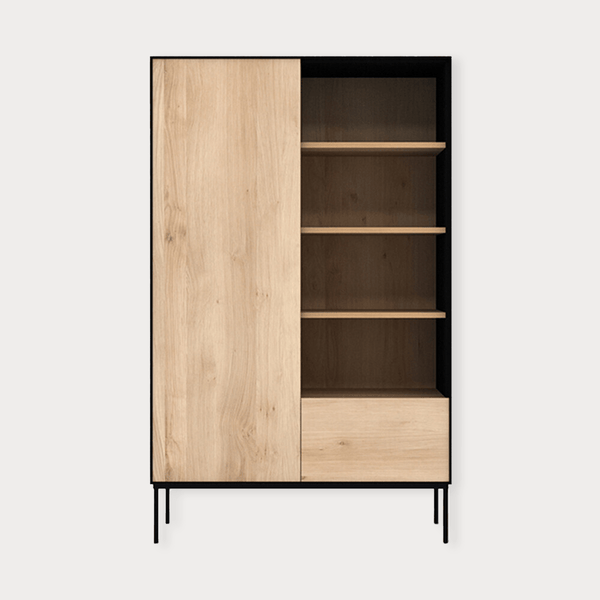 Ethnicraft Blackbird Storage Cupboard in natural oak with one door, drawer, and open shelving on black metal legs