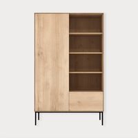 Ethnicraft Whitebird Storage Unit in natural oak with one door, one drawer, open shelves, and black metal legs.