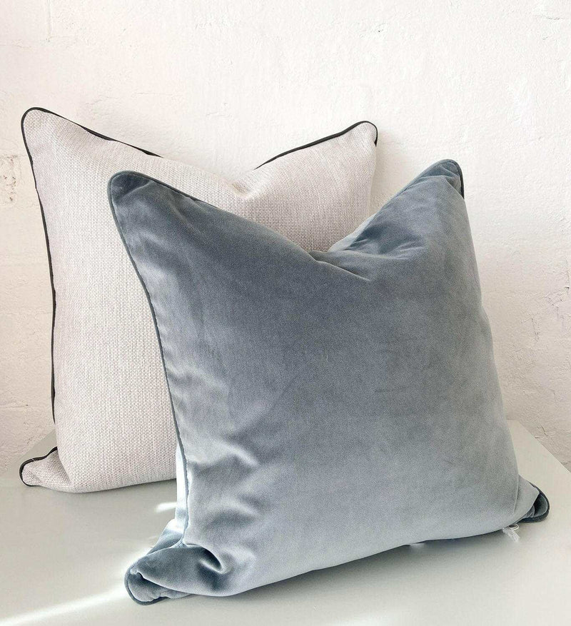 Handmade norsu cushion pair featuring Lindeman Snow fabric with charcoal piping and a soft grey velvet cushion.