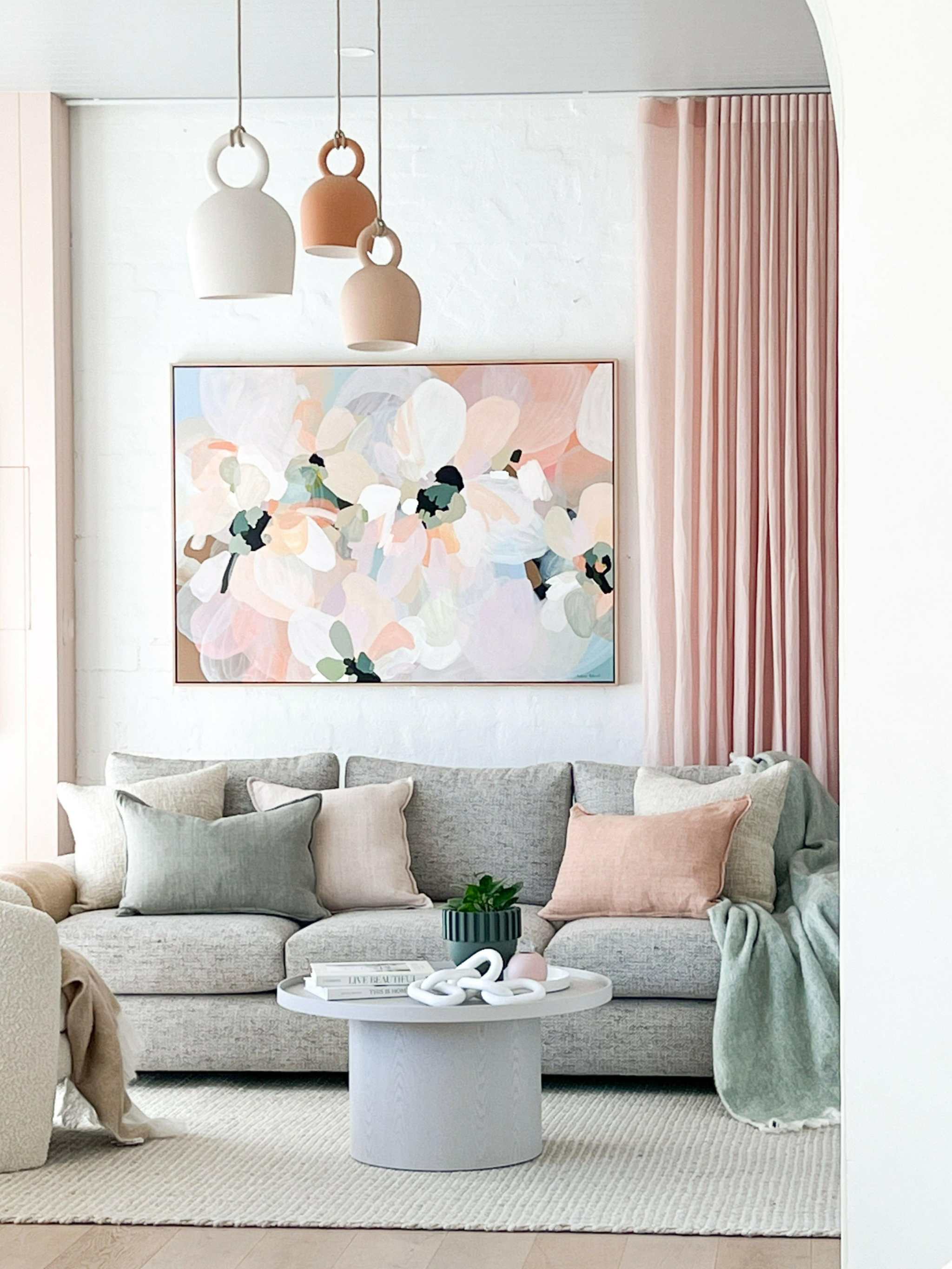 Modern norsuHOME sofa in neutral tones with pastel pillows and contemporary decor in stylish living room