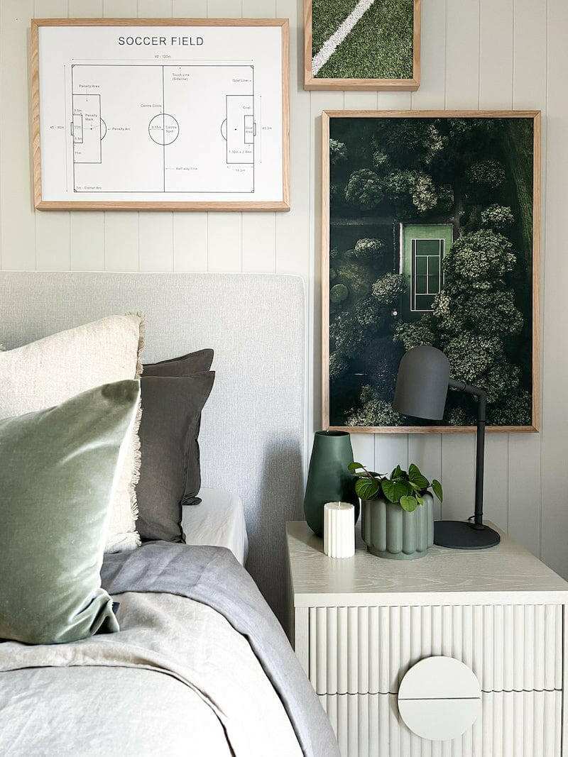Pia desk lamp in charcoal color on a bedside table with modern decor and artwork above
