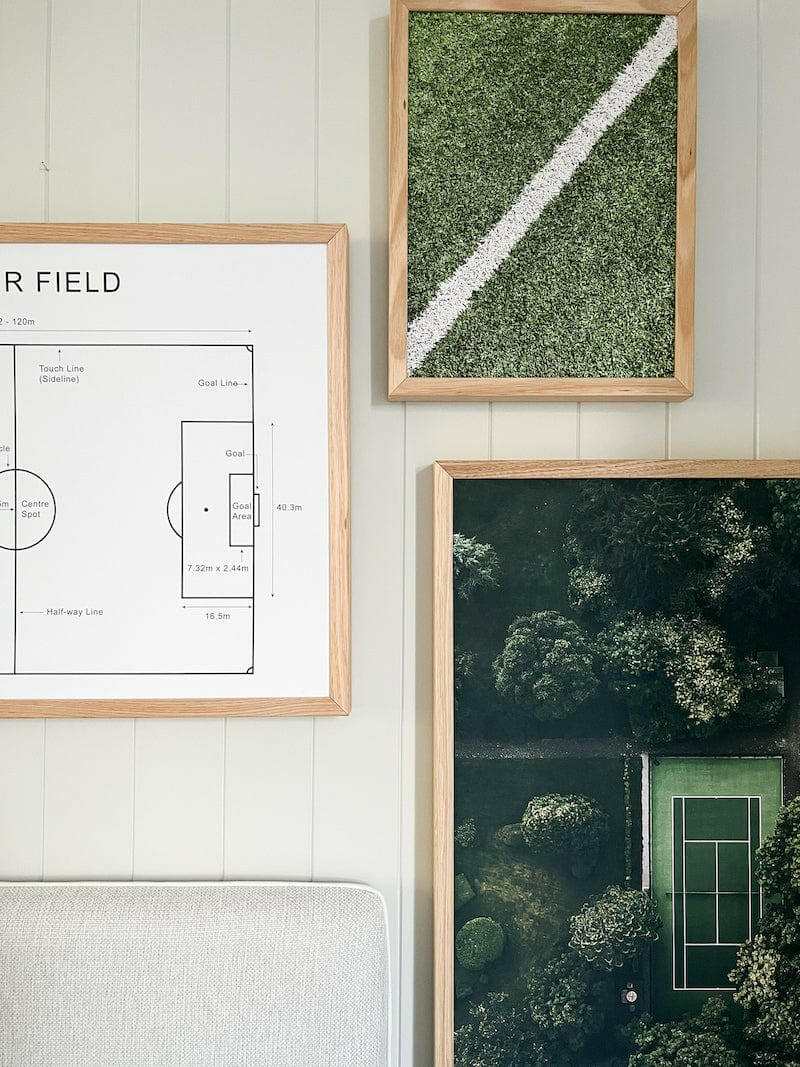 Set of three framed wall art prints featuring a soccer field diagram, a close-up green grass texture, and an aerial view of a tennis court surrounded by trees.