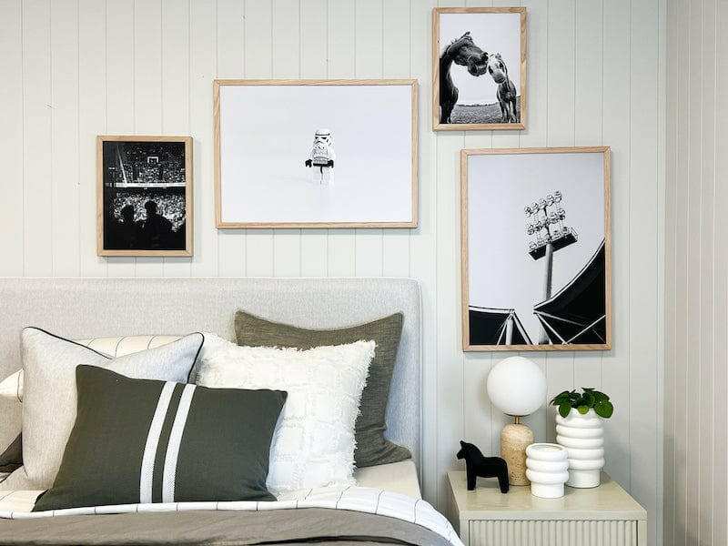 norsu Studio Washable Cushion in olive green on bed with white and neutral cushions in modern bedroom setting