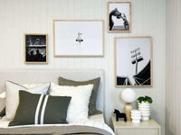 norsu Studio Washable Cushion in olive green on bed with white and neutral cushions in modern bedroom setting