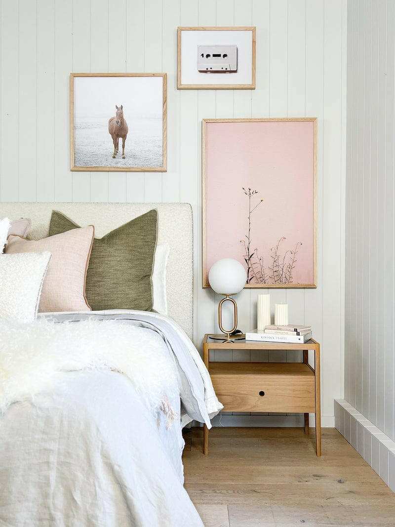 Ethnicraft Spindle Bedside Table in natural oak with single drawer and smokey glass top next to bed in modern bedroom setting