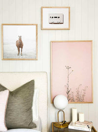 Modern brass desk lamp with frosted glass shade on bedside table in stylish bedroom setting