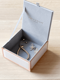 Sara Jewellery Box blush small glass box with grey velvet lining and Art-Deco bevelled edges containing jewelry.