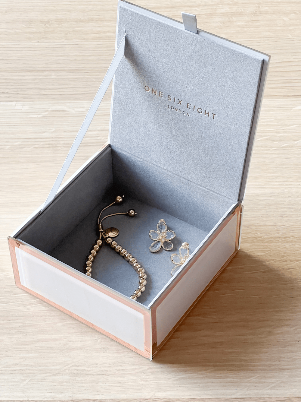 Sara Jewellery Box blush small glass box with grey velvet lining and Art-Deco bevelled edges containing jewelry.