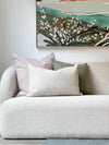 norsu Studio Washable Cushion in blush on white sofa with green and pink cushions and abstract wall art