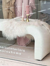 Zaru Boucle Bench seat in oatmeal with curved design and wool throw draped over, placed near window display