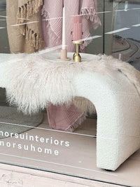 Zaru Boucle Bench seat in oatmeal with curved design and wool throw draped over, placed near window display