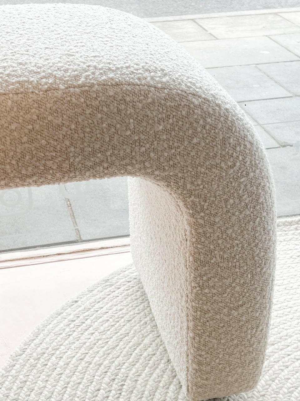 Close-up of Zaru Boucle Bench seat corner in oatmeal fabric with curved design and textured upholstery