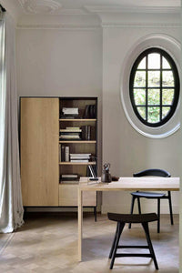Ethnicraft Blackbird Storage Cupboard in natural oak with one door and open shelves in a modern office setting
