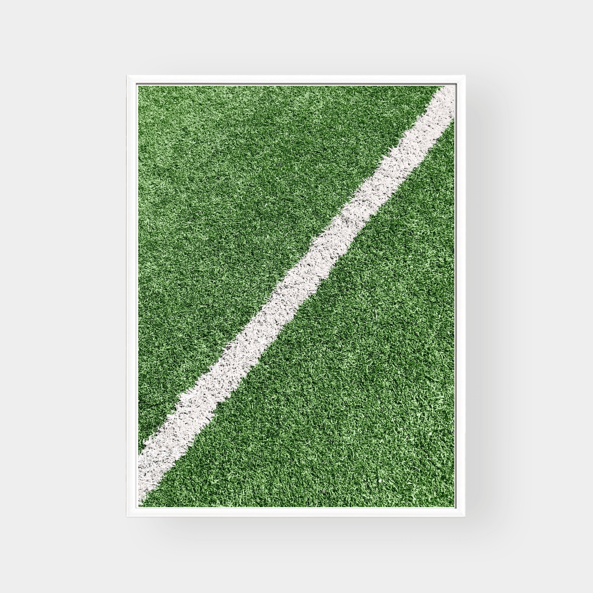 Framed wall art print of green grass with a white line on premium fine art paper in various sizes