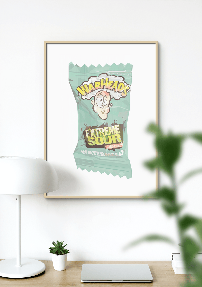 Dom Gauci Kids Art Print featuring Warheads Extreme Sour candy design in framed print displayed on wall above desk.