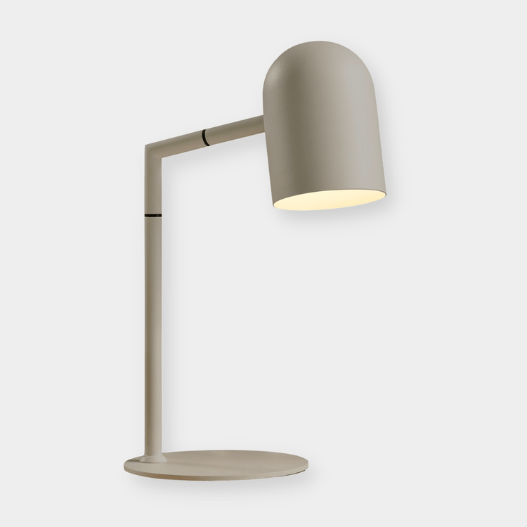Pia Task Lamp in bone color with modern architectural design, adjustable arm, and round base for desk or bedside use.