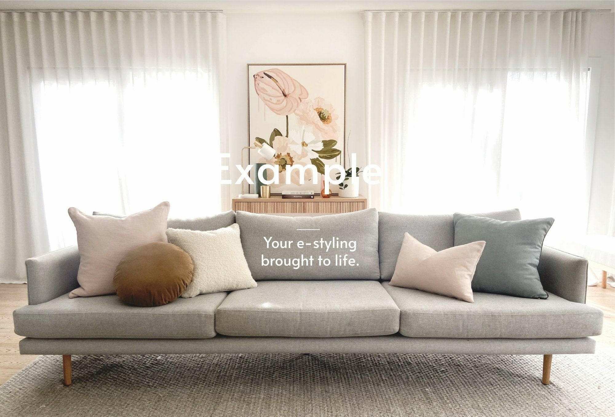 Modern grey sofa styled with assorted cushions in neutral tones in a bright living room setting
