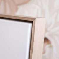 Close-up of framed limited edition fine art canvas print with wooden frame and textured white canvas surface