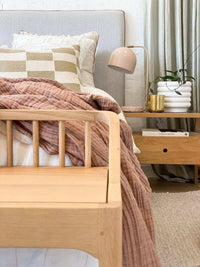 White porcelain Alder Pot with a quirky bubbly texture displayed on a bedside table in a cozy bedroom setting