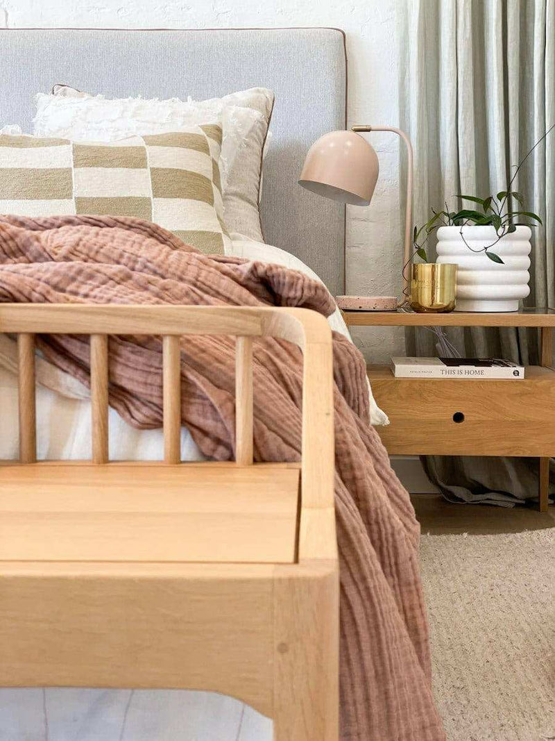 White porcelain Alder Pot with a quirky bubbly texture displayed on a bedside table in a cozy bedroom setting