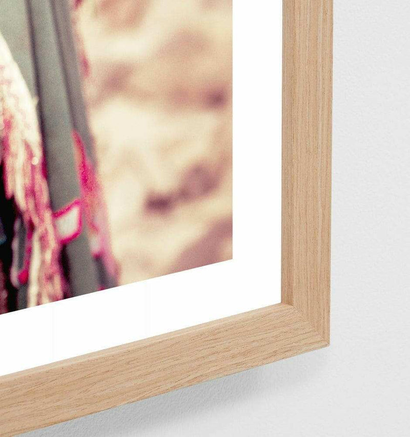 Middle of Nowhere framed photographic print featuring a camel in traditional Bedouin dress, oak frame behind glass.
