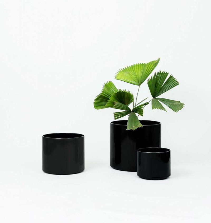 Set of three Benny Planter Black powder-coated stainless steel pots with drainage holes, suitable for indoor and outdoor use.