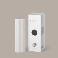 White cream Black Blaze Wide Candle column pillar candle next to its packaging box