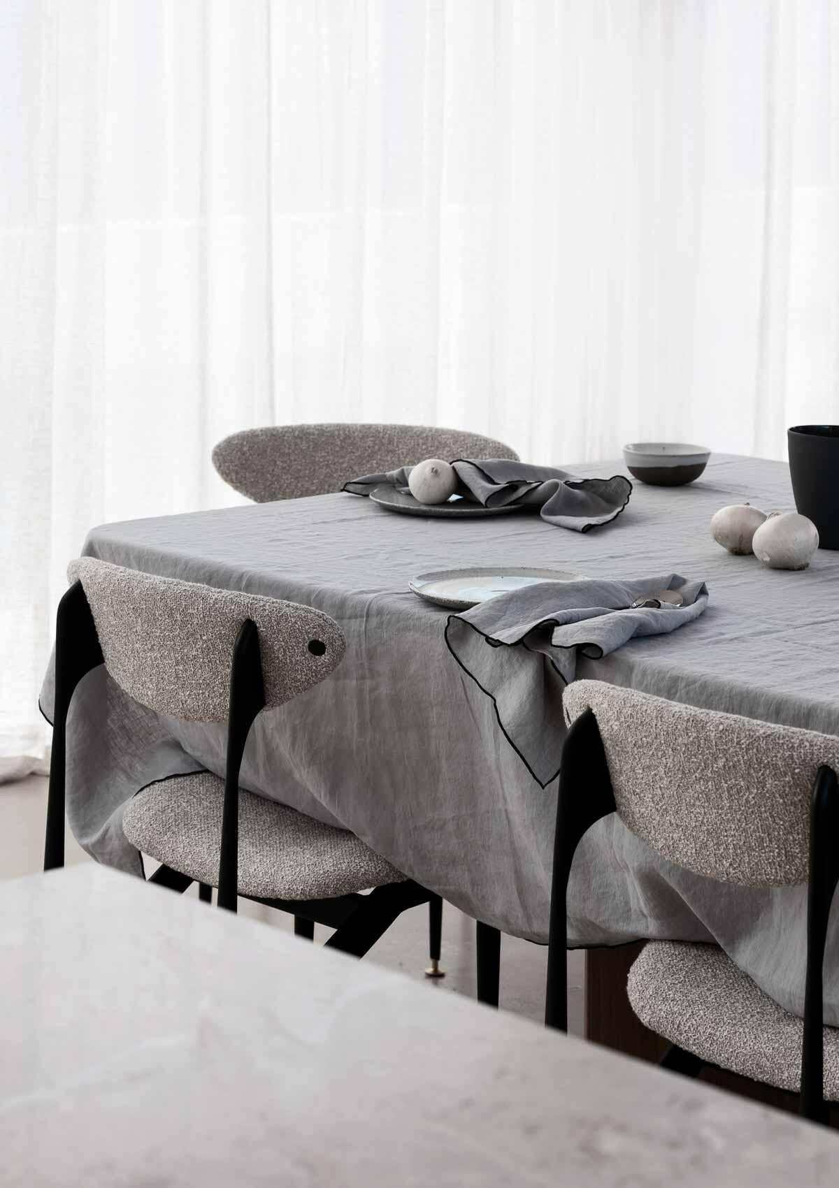 Rendr Amara Stitch 100% linen tablecloth in cool grey with embroidered edging on dining table