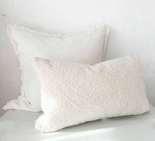 Eadie Lifestyle Luca white boho cushions with hand-frayed edges in various sizes on a white surface