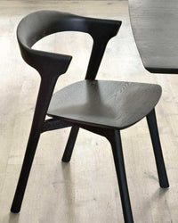 Black Ethnicraft Bok Dining Chair made of solid European oak with a sculptural, contemporary design.