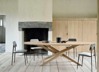 Ethnicraft Dining Table Mikado in natural oak with inward flowing X-shaped legs in a modern dining room setting