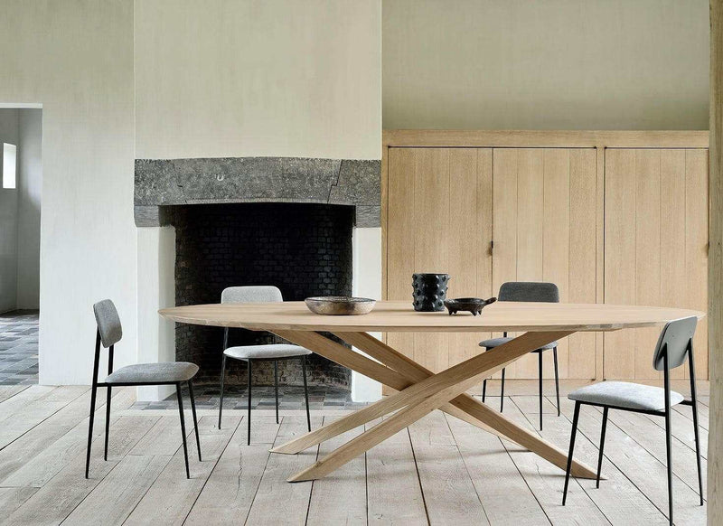 Ethnicraft Dining Table Mikado in natural oak with inward flowing X-shaped legs in a modern dining room setting