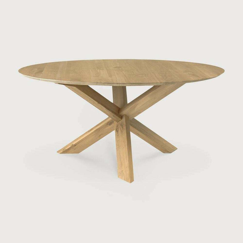 Ethnicraft Round Circle Dining Table made of solid natural oak with a round top and crossed wooden legs.