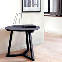 Ethnicraft Side Table Tripod Black solid oak round table with angled legs in modern room setting
