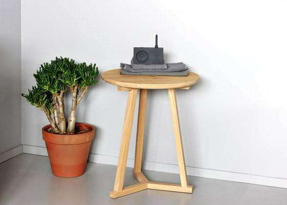 Ethnicraft Side Table Tripod in natural oak wood next to potted plant on a gray floor against white wall