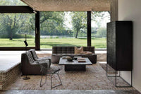 Dark grey Ethnicraft Sofa N701 1 seater in modern living room with large windows and garden view