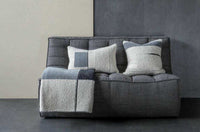 Dark grey Ethnicraft Sofa N701 2 seater with textured cushions and throw blanket