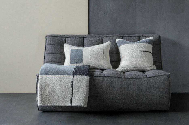 Dark grey Ethnicraft Sofa N701 2 seater with textured cushions and throw blanket