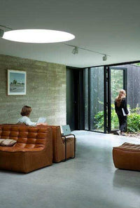 Ethnicraft Sofa N701 2-seater in old saddle brown aniline leather in modern living room setting