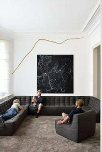Ethnicraft Sofa N701 dark grey corner modular sofa set in modern living room with people sitting