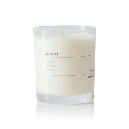 Grace and James Antibes scented candle with fir needle, blackcurrant, and wild rose fragrance in clear glass jar