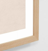 Close-up of oak-framed Middle of Nowhere High Tide beach print with glass covering