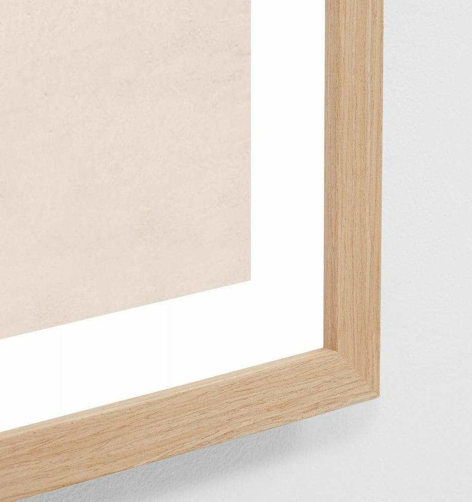 Close-up of oak-framed Middle of Nowhere High Tide beach print with glass covering
