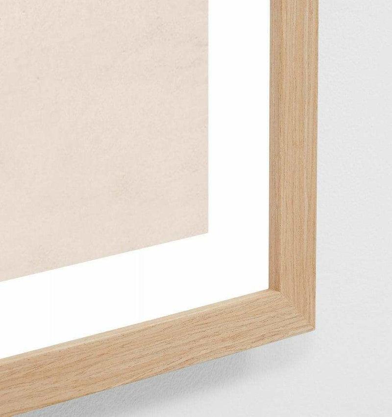 Close-up of oak-framed Middle of Nowhere High Tide beach print with glass covering
