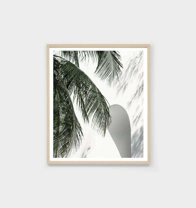 Framed photographic print of palm leaves and island archway in oak frame for modern decor