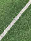 Close-up of green grass turf with a white line, wall art print available in various sizes and framed or unframed options