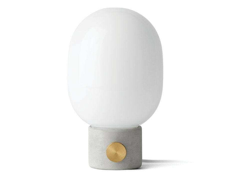 Menu JWDA Concrete Lamp with white glass shade and concrete base featuring a brass dimmer knob.