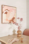 Kimmy Hogan Limited Edition Fine Art Canvas Print "Dusk" with abstract pink and brown tones in floating oak frame above wooden table with decorative vase and glass