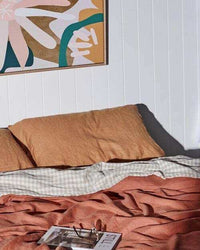 Kimmy Hogan Limited Edition Flowerbed III fine art canvas print with vibrant colors and floating oak frame above bed