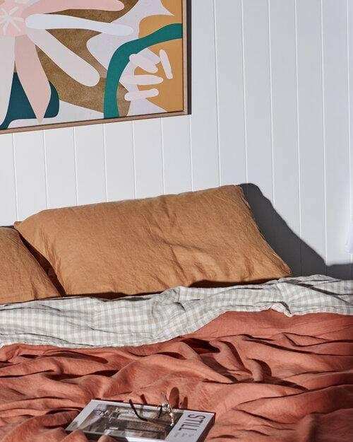 Kimmy Hogan Limited Edition Flowerbed III fine art canvas print with vibrant colors and floating oak frame above bed